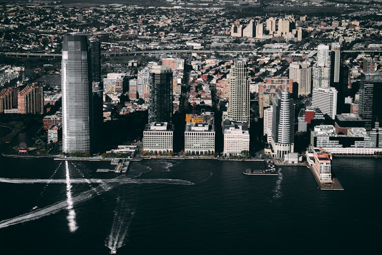 Dramatic aerial view of the Jersey City skyline showcasing prominent skyscrapers along the Hudson River.
